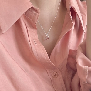 Macro shot of 925 sterling silver hollow heart pendant on a fine necklace chain
