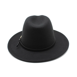 Close-up of black felt fedora hat featuring a leather band with gold metal buckle detail