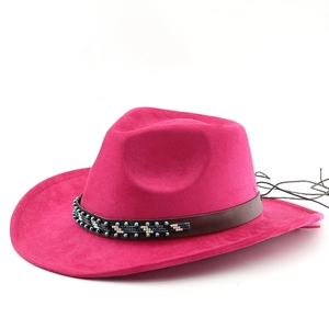 Detail of rose red suede cowboy hat featuring ethnic beads on a brown leather band