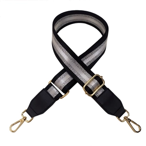 Adjustable black fabric shoulder strap for bags with silver threads and gold metal clasps