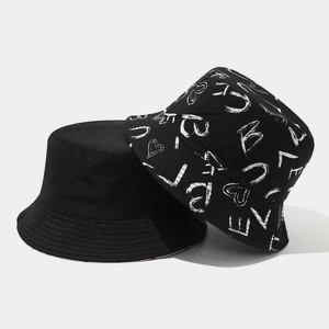 Double-sided reversible black bucket hat with graffiti prints and solid minimalist design