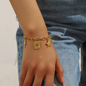 Vintage gold plated stainless steel O-chain bracelet with sun and moon charms on a wrist