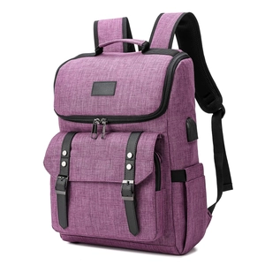 Detail view of purple laptop backpack showing integrated USB charging port and side pocket