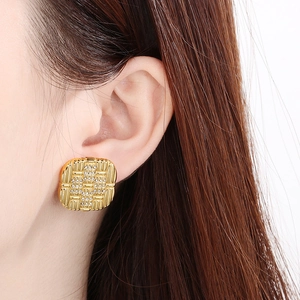 Detailed close-up of a 18K gold plated square earring with inlaid sparkling rhinestones