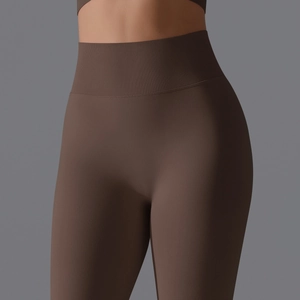 Close-up of high-waisted seamless yoga leggings with ribbed waistband in dark brown