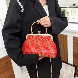 Red embroidered crossbody bag with gold clasp and metal chain strap for women