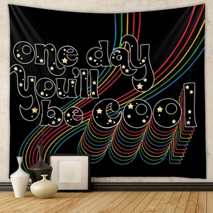 Detail view of rainbow wave pattern and vintage text on black bohemian wall tapestry