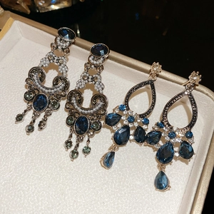 Detailed view of vintage crystal pearl drop earrings in a jewelry storage box