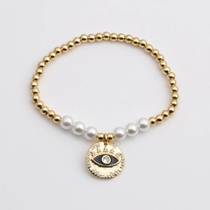 Bracelet extensible à perles dorées avec perles blanches et pendentif cœur œil protecteur