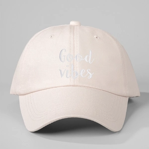 Classic beige cotton baseball cap featuring white Good vibes embroidery in a casual style