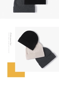 Detailed close-up of knit texture on fisherman hats in black, white, and grey colors