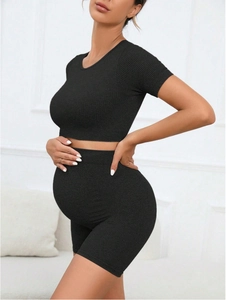 Detail of black seamless ribbed maternity sportswear showing high stretch fabric fit