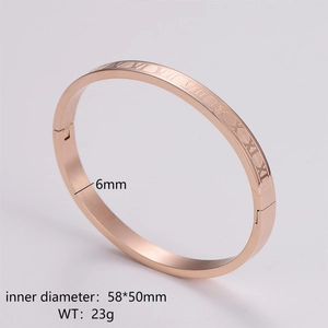 Detail view of rose gold stainless steel bangle with engraved Roman numerals