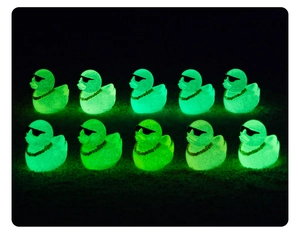 Luminous green miniature ducks with sunglasses and gold chains glowing in dark