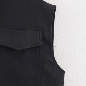 Black casual sleeveless jacket featuring a textured fabric and front flap pocket detail