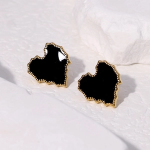 Minimalist gold-edged heart earrings with black enamel center on stone base