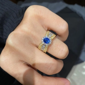 Vintage two-tone lace ring with oval sapphire blue stone and intricate diamond details