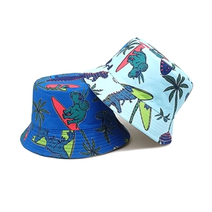 Reversible kids bucket hat with navy and light blue dinosaur surfing prints for sun protection