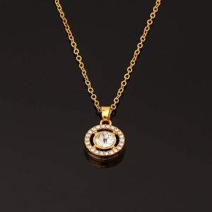 Close-up of gold necklace featuring a round pendant with large white center stone