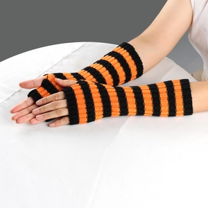 Close-up of black and orange striped knitted fingerless arm warmers on white fabric