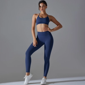 Detail of dark blue seamless yoga set showing high-waist leggings and racerback sports bra