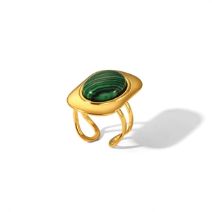Detailed macro view of a vintage gold-plated ring with a striped green malachite stone