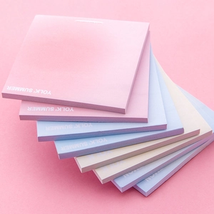 Pastel gradient sticky notes in fan-shaped layers on pink background for stationery