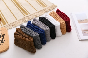 Row of colorful coral fleece winter socks showcasing soft plush texture and thick material
