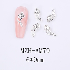 Macro view of silver horseshoe flower nail art charms with sparkling crystal rhinestones