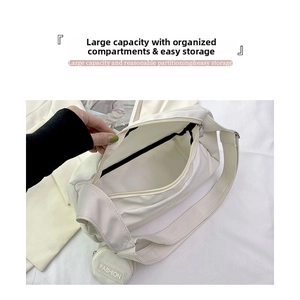Detailed view of the spacious main compartment and round fashion coin purse on white tote bag