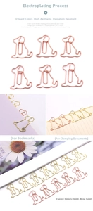 Detail of dog shaped paper clips in gold and rose gold finish used as bookmarks