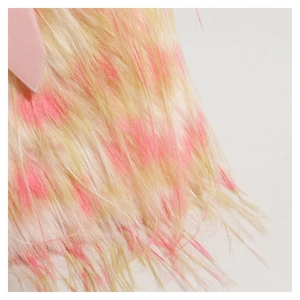 Close-up of faux fur texture in pale yellow and pink stripes on a stylish crossbody bag