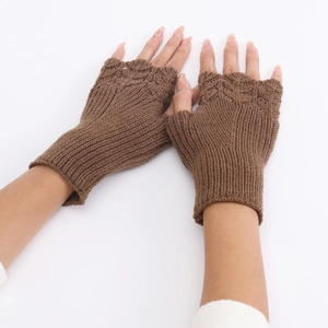 Close-up of brown knit texture on fingerless gloves showing detailed woolen stitching