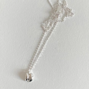 Minimalist 925 sterling silver necklace featuring a double bean pendant and thin O-chain