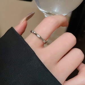Detailed view of silver bamboo texture ring with sparkling white zircon stones