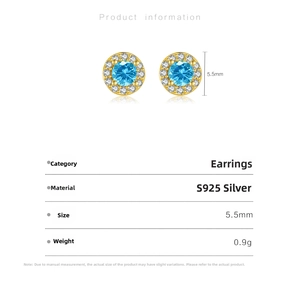 Macro shot of S925 silver stud earrings with blue stone and halo diamond accents