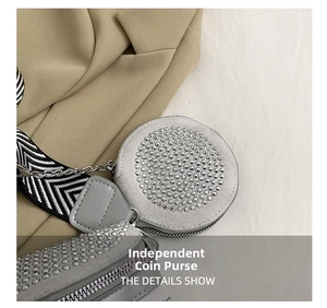 Macro detail of round mini pouch with silver studs and herringbone webbing strap