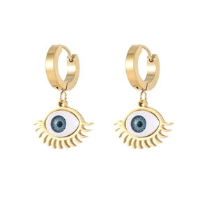 Golden evil eye earrings with blue pupil and lash details on white background