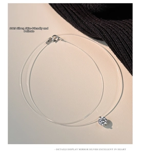 Close-up of S925 sterling silver moissanite pendant on a transparent invisible fishing line