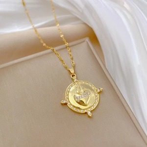 Elegant gold titanium necklace with a crystal-encrusted sacred heart and cross pendant