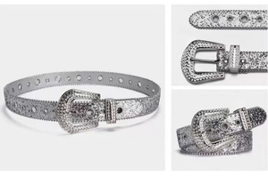 Detail of silver rhinestone belt with western buckle and sparkling metal eyelets