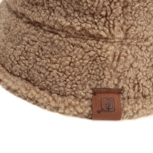 Brown faux shearling bucket hat with premium textured wool and leather logo patch