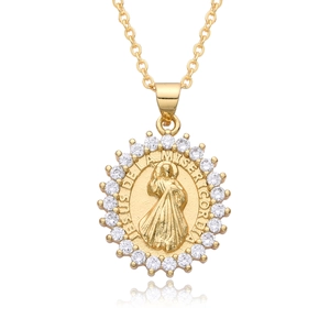 Detail of gold religious pendant necklace with Jesus carving and sparkling zircon border