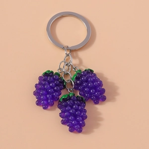 Detail of purple resin grape keychain pendants with polished silver metal rings