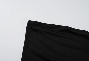 Detailed close-up of the fine edge stitching on the black strapless cocktail dress fabric