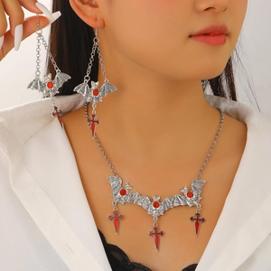 Gothic bat and red cross necklace set worn by model on a professional white background