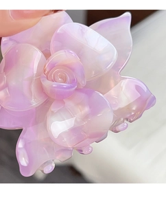 Close-up of pink gradient flower hair claw clip with glossy acrylic material details