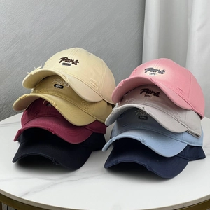 Group display of colorful distressed baseball caps with Paris 1976 embroidery detail