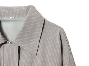 Macro shot of striped jacket collar with silver zipper and size M printed detail