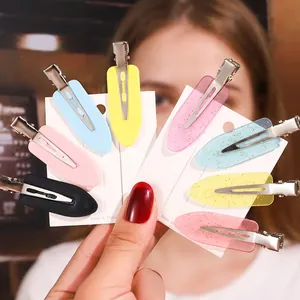 Colorful leaf-shaped hair clips in matte and glitter finishes with metal alligator clips
